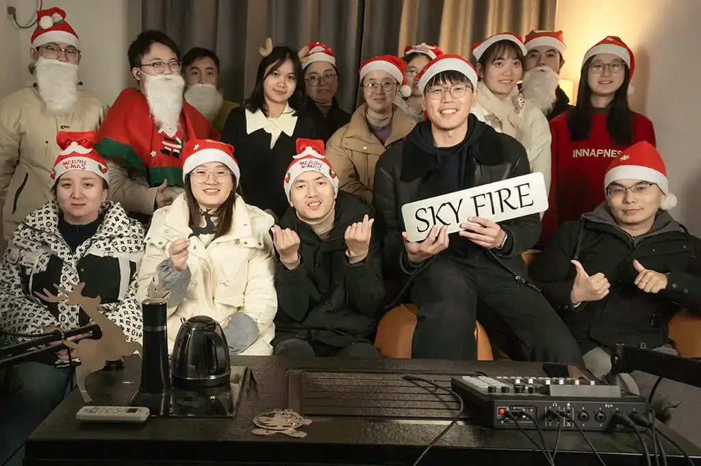 Group photo of Sky Fire team celebrating Christmas in festive hats and costumes, holding a sign that says 'SKY FIRE'.