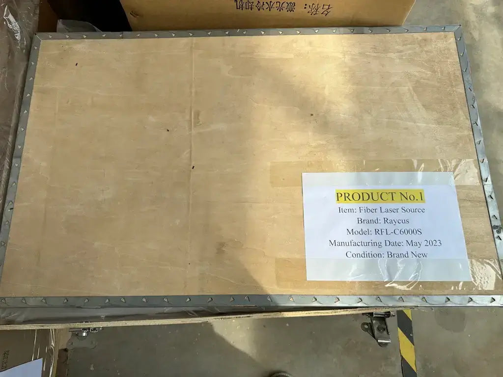 Wooden crate with labeled Fiber Laser Source, Raycus RFL-C6000S, manufactured May 2023, almost new condition.