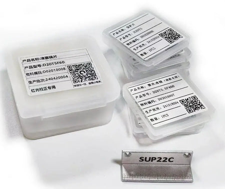 Laser consumables package containing various lenses and a label showing model SUP22C for fiber laser cleaning.